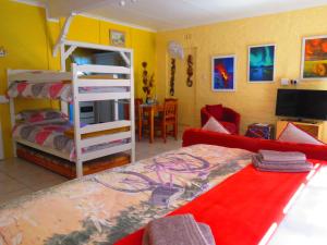 een slaapkamer met een stapelbed en een woonkamer bij Footprints of Knysna in Knysna