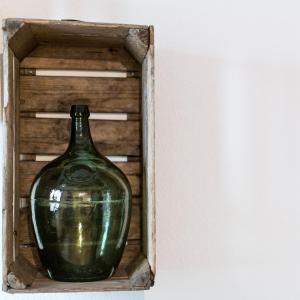 a bottle of water sitting in a wooden box at La Maison du Batelier in Colmar