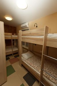 a room with three bunk beds in a room at OVB Hostel in Ob