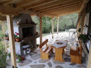 a patio with a table and an outdoor oven at Къща за гости Ножери in Tryavna