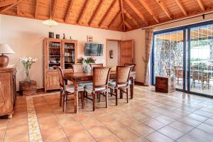 a dining room with a wooden table and chairs at Casa Amalia in Los Llanos de Aridane