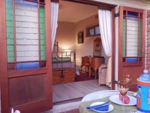 a room with a door open to a room with a table at Swellendam Overnight Accommodation in Swellendam