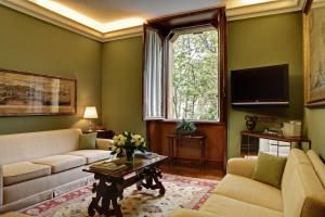 a living room with a couch and a table at Villa Spalletti Trivelli - Small Luxury Hotels of the World in Rome