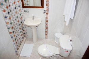 a white toilet sitting next to a sink in a bathroom at Hotel Dorado Plaza Centro Histórico in Cartagena de Indias