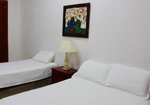 Postel nebo postele na pokoji v ubytování Hotel Dorado Plaza Centro Histórico