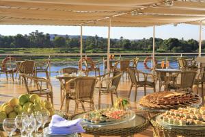 a table with plates of food on top of a deck at JAZ Crown Empress Nile Cruise - Every Monday from Luxor for 07 & 04 Nights - Every Friday From Aswan for 03 Nights in Luxor