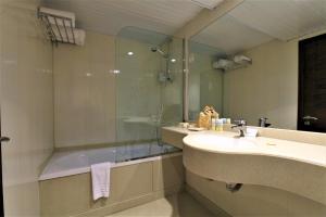 a bathroom with a shower and a sink and a tub at Iberotel Crown Empress Nile Cruise - Every Monday from Luxor for 07 & 04 Nights - Every Friday From Aswan for 03 Nights in Luxor