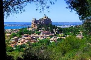 a town on a hill with a castle on top at Guest House Provencal in Vitrolles