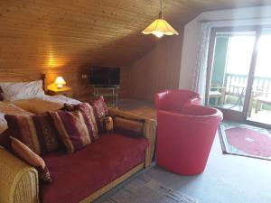 a living room with a couch and a television in a room at Haus Sonne in Kirchham