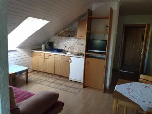 an attic kitchen with a sink and a stove at Haus Sonne in Kirchham