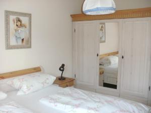 a bedroom with two beds and a mirror at Haus Sonne in Kirchham