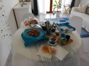 a table with a tray of pastries on it at B&B Suite Vela Bianca in Salerno