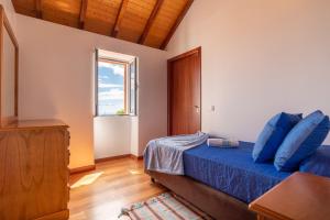 Postel nebo postele na pokoji v ubytování Casa Raivinha