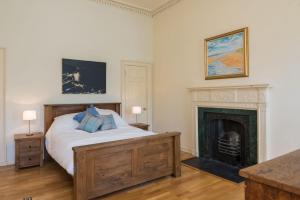 a bedroom with a bed and a fireplace at Gayfield Place in Edinburgh