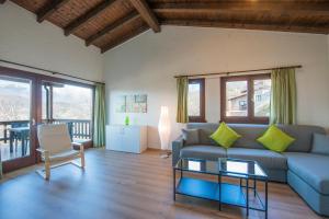 a living room with a couch and a table at Centro Cadro Panoramica in Lugano