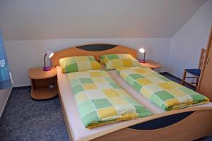 a bedroom with a large bed with two night stands at Ferienwohnungen Familie Looks in Klein Zicker
