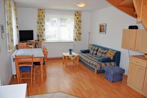 a living room with a couch and a table at Ferienwohnungen Familie Looks in Klein Zicker