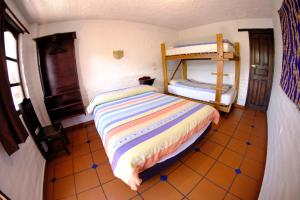 a bedroom with a bed and a desk at Hostal L'Auberge Inn in Quito