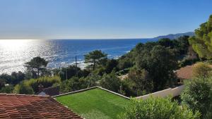 a house with a view of the ocean at Residence Canella in Sari Solenzara
