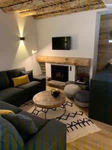 a living room with a couch and a fireplace at Chalet Las Avellanas in Arinsal