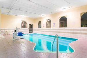 a swimming pool in a building with a tile floor at Days Inn by Wyndham Mount Vernon in Mount Vernon