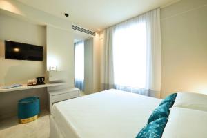 Posteľ alebo postele v izbe v ubytovaní Boutique Hotel de la Ville