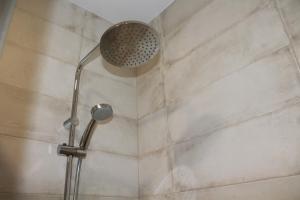 a shower stall with a glass shower door at Hotel Torre del Oro in La Rinconada