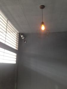 a light hanging from a ceiling in a room at Temporal Eva in San Justo