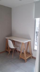 a table and a chair in a room at Temporal Eva in San Justo