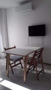 a table and a chair in a room at Temporal Eva in San Justo