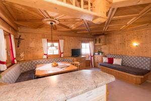 a living room with a couch and a table at Stoffen Zuhaus in Alpbach