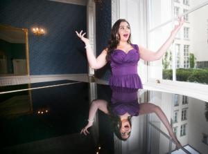 a woman in a purple dress is dancing on a mirror at The Merrion Hotel in Dublin