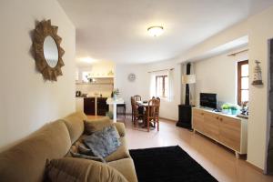 a living room with a couch and a kitchen at Casa do Avô Zé in Caminha