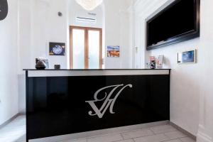 a black and white reception desk in a room at Al Viminale Hill Inn & Hotel in Rome