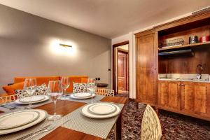 a dining room with a table with plates and wine glasses at San Marco Superior Apartments in Venice