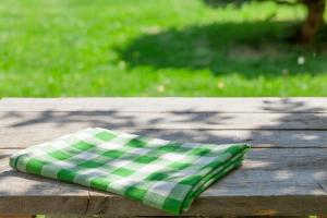 a green and white napkin sitting on a wooden table at Extended Stay America Suites - North Chesterfield - Arboretum in Richmond