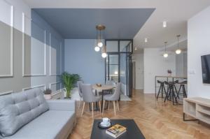 a living room with a couch and a table at Ermine Suites in Krakow