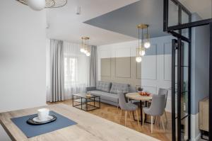 a living room with a couch and a table at Ermine Suites in Kraków