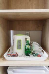 a green and white toaster sitting on a shelf at Отель "Даймонд Луговая" in Kursk