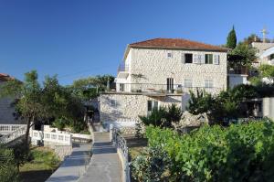 a house on the side of a hill at Apartments Olive Tree in Hvar