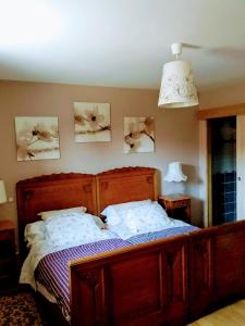 a bedroom with a wooden bed with two pillows at Bim Cathele in Burbach