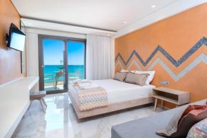 a bedroom with a bed and a balcony with the ocean at Reverie in Limenaria
