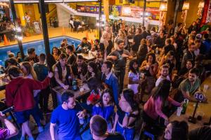 a crowd of people at a party in a bar at Wild Rover Huacachina in Ica