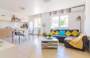 a living room with a couch and a table at Apartments Nicole in Pula