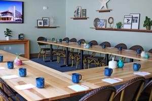 a large conference room with wooden tables and chairs at East Austin Hotel in Austin