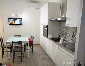 a kitchen with a table and chairs in a kitchen at Casa Vacanze Dany in Taranto