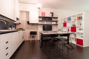 a kitchen with white cabinets and a table and chairs at Italianway - Polese 36 B in Bologna