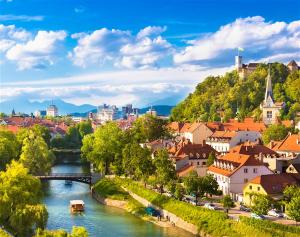 a view of a river in a city with buildings at LjubljanaArt Apartment in Ljubljana