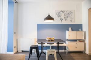 una sala da pranzo con un tavolo nero e due sgabelli di Mancidue a Trento