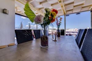 a table with a vase filled with flowers on it at Vila Marina - Luxurious apartment - Sea view in Vilamoura